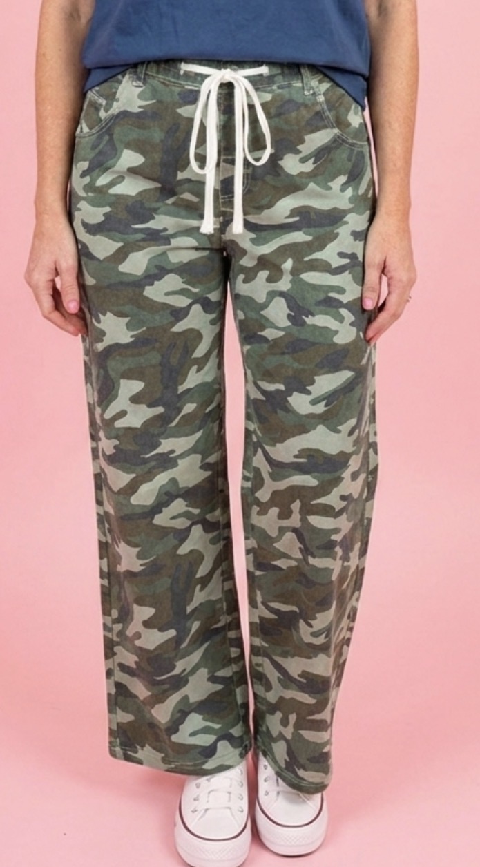 Camo print wide leg drawstring pants on a pink backdrop