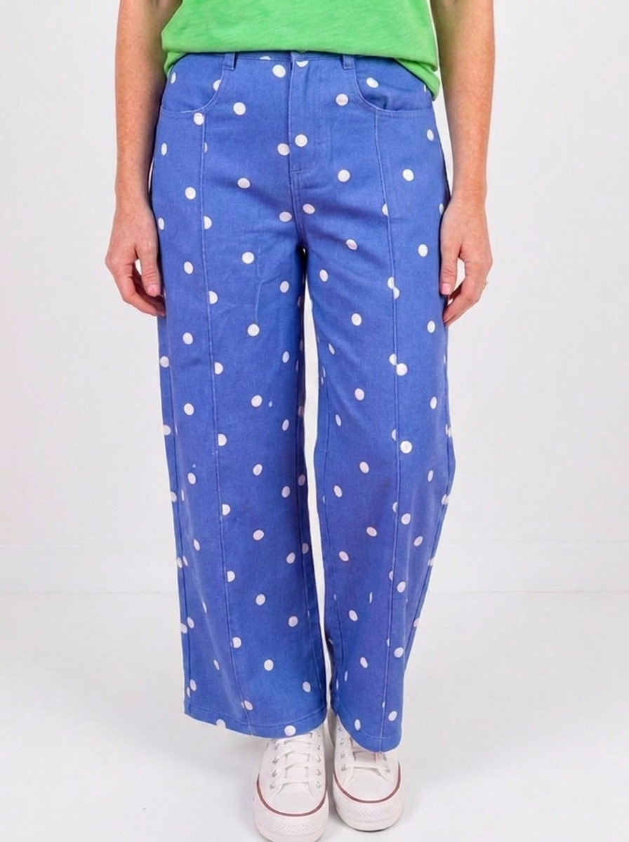 Blue polka dot wide leg jeans on a white backdrop